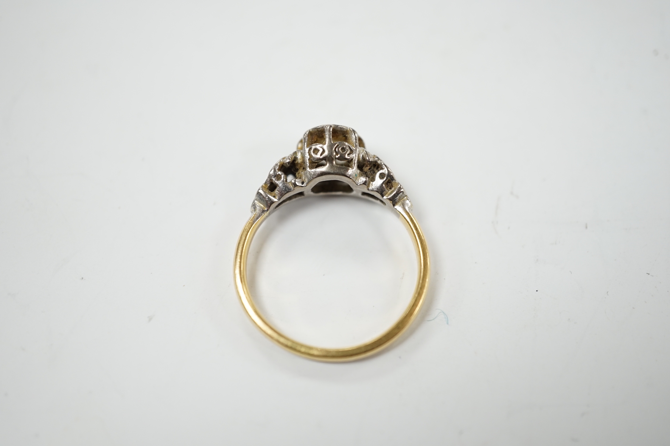 A yellow metal and illusion set solitaire diamond ring, size O, gross weight 3.8 grams.
